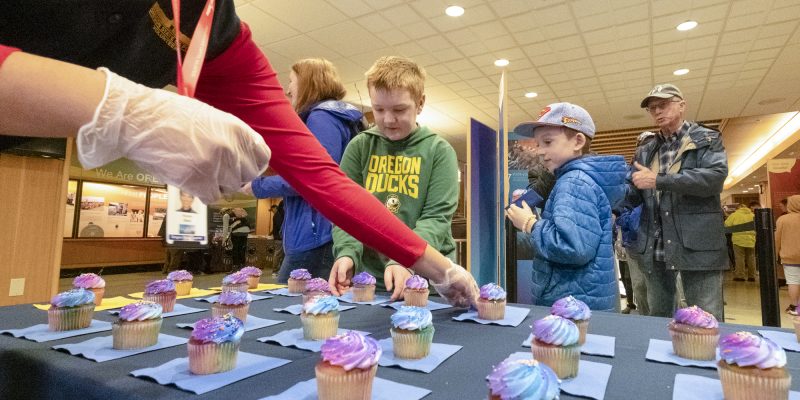 Families receiving free cupcakes during the Birthday Celebration.