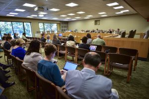 People seated in a hearing room