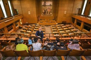 Volunteer tour guide shares the legislative process with schoolchildren.