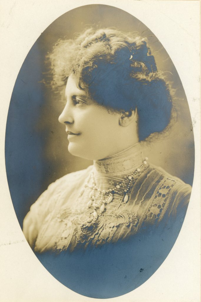 A photograph portrait of a woman from the shoulders up in early 1900s dress