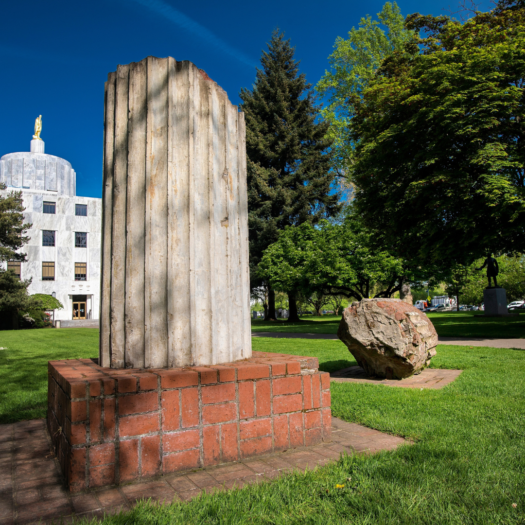 The second Capitol's ruined columns in State Capitol State Park, with the current Capitol in the distance.