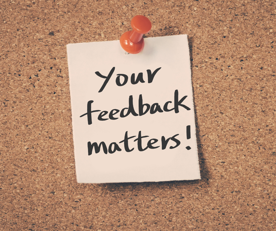 A note stuck in a corkboard that says "your feedback matters"