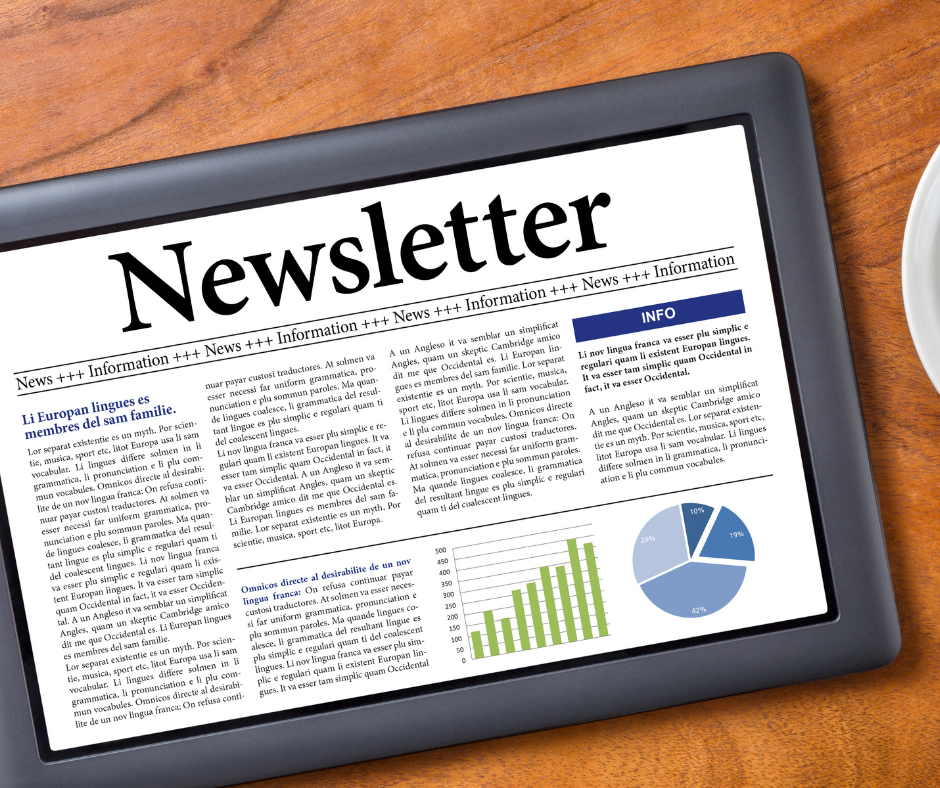 a tablet displaying the word 'newsletter' sitting on a table.