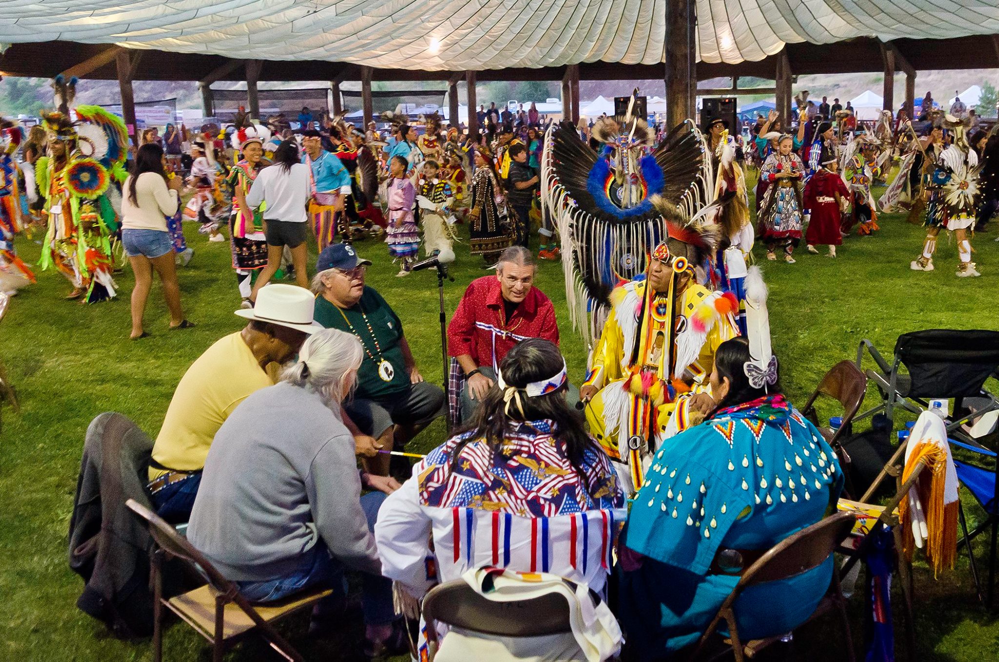 Tribal members gather in circle.