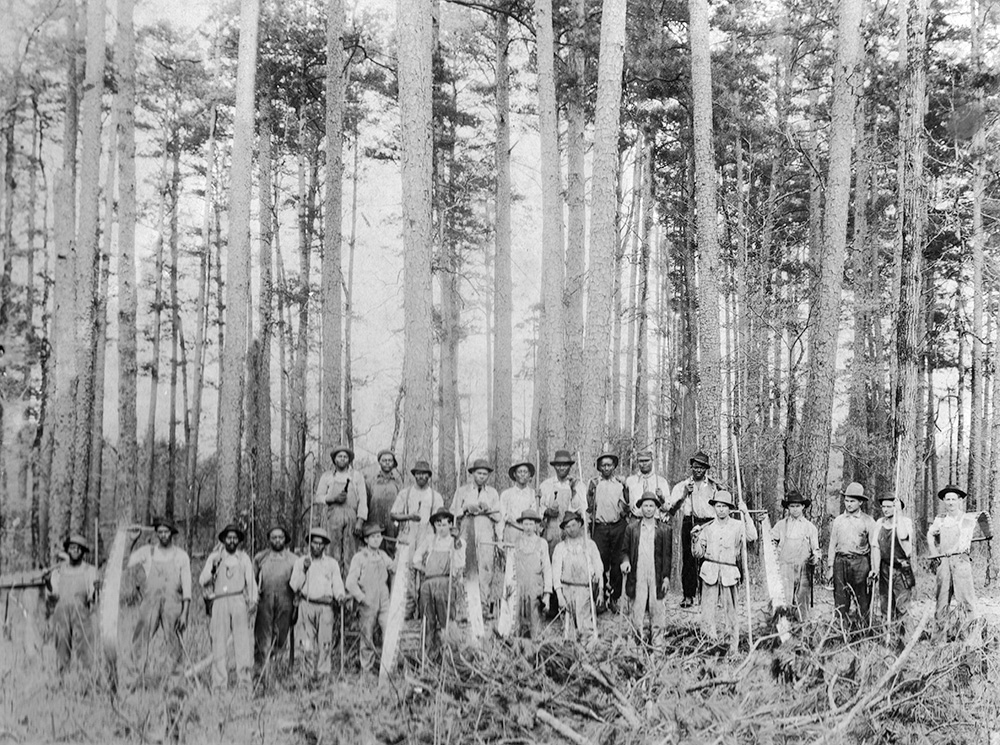 black and white photograph of black Oregon loggers in front of trees